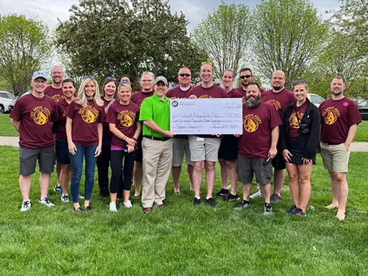 A group being awarded a large check