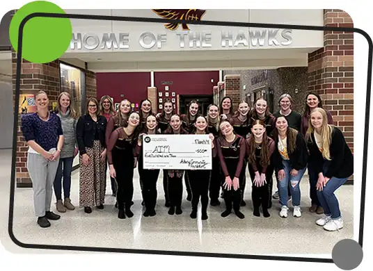 Ankeny High School students hold up a $500 grant check from the Ankeny Community Foundation to the Ankeny Instrumental Music Foundation