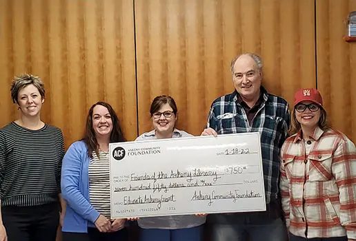 Representatives of the Friends of the Ankeny Library accept a $750 grant check from the Ankeny Community Foundation
