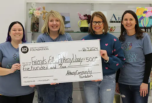 Representatives of the Friends of the Ankeny Library accept a $500 check from the Ankeny Community Foundation