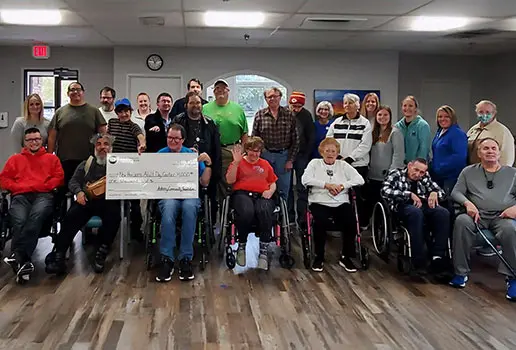 Residents and staff at New Horizons Adult Day Center accept a grant check from the Ankeny Community Foundation