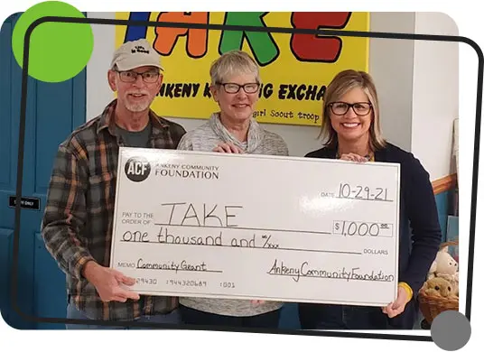 The Ankeny Klothing Exchange (TAKE) accepts a $1,000 grant from the Ankeny Community Foundation