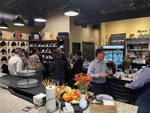 A crowd mingles at WineStyles Tasting Station in Ankeny for an Ankeny Community Foundation fundraiser