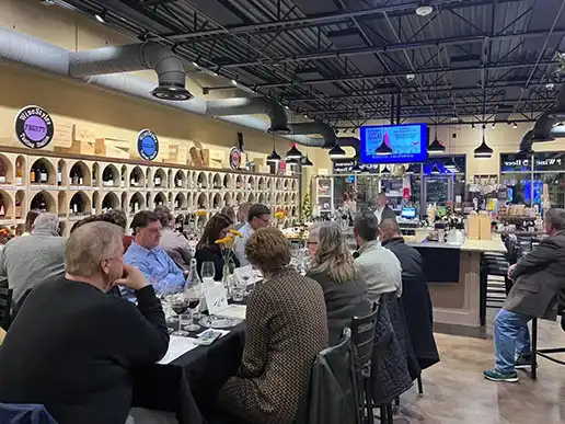 Attendees sit at tables inside WineStyles Tasting Station for the 