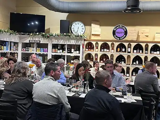 A crowd of attendees sit at tables at the Ankeny Community Foundation's 